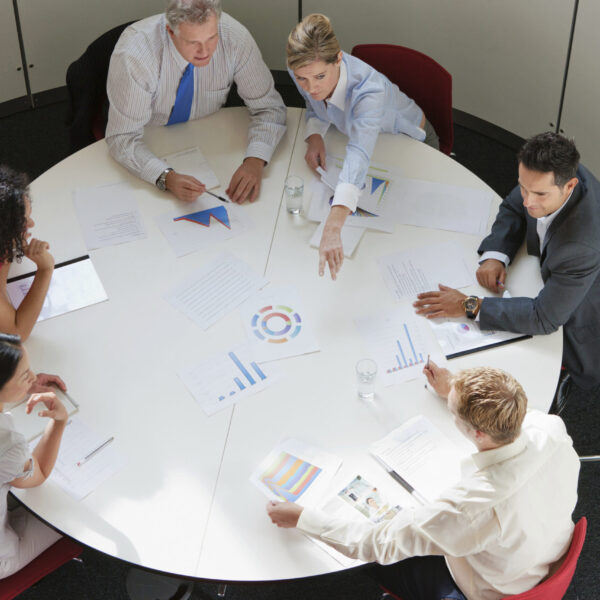 Business colleagues working together in meeting room, high angle view